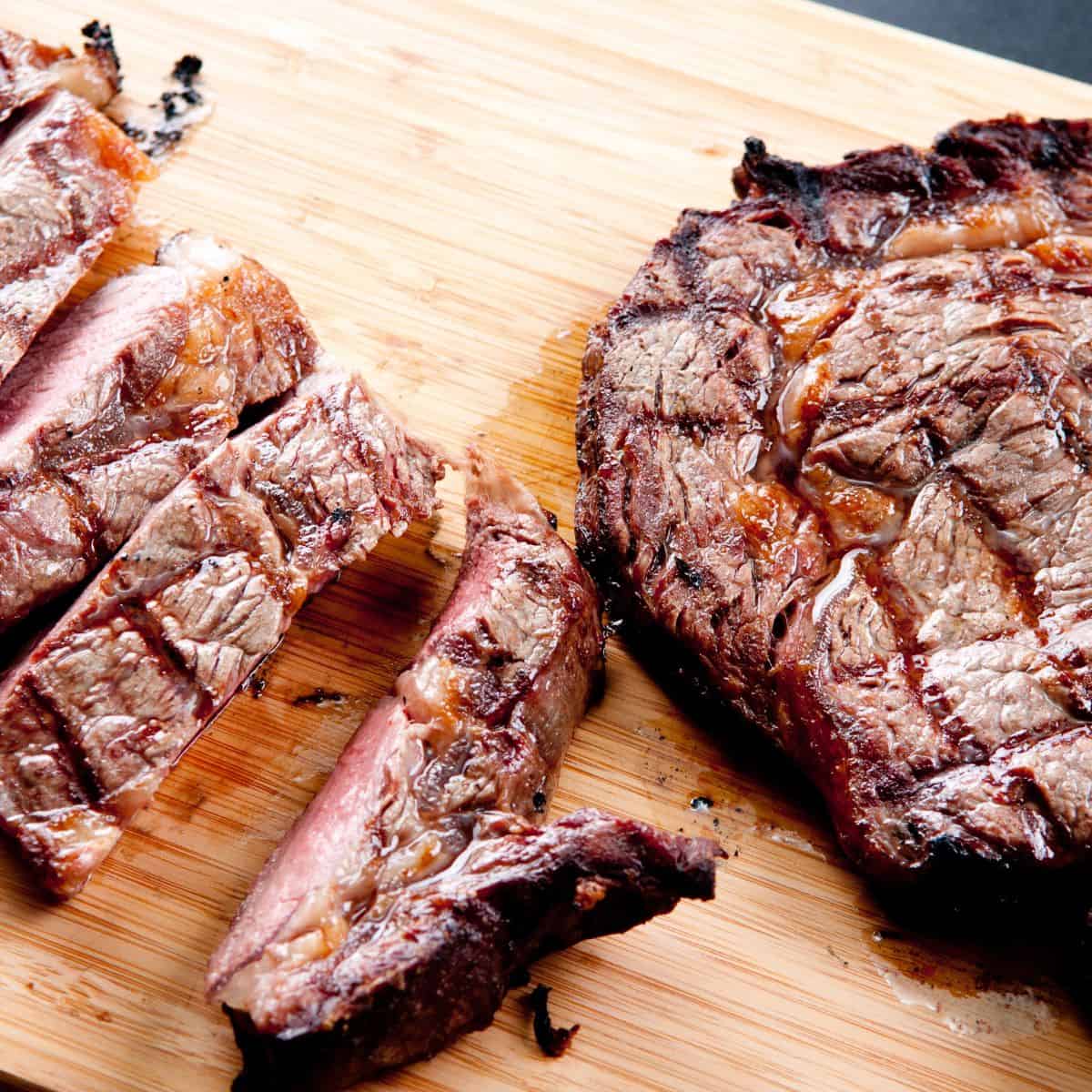 Reverse seared steak sliced on a cutting board