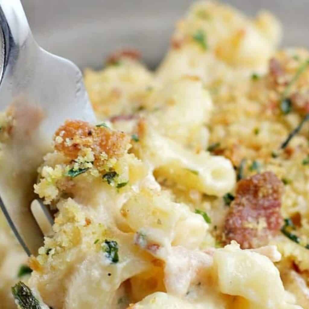 Fork digging into a bowl of the ultimate macaroni and cheese