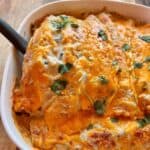 Cheesy White chicken enchiladas cooked in a white dish