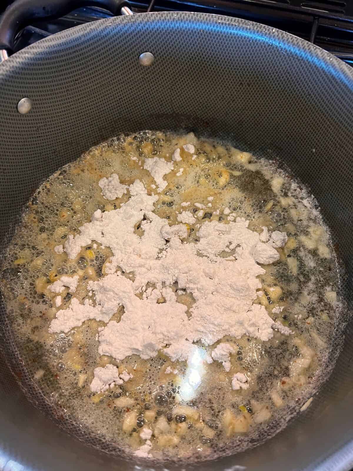 add flour to sauteed butter and garlic