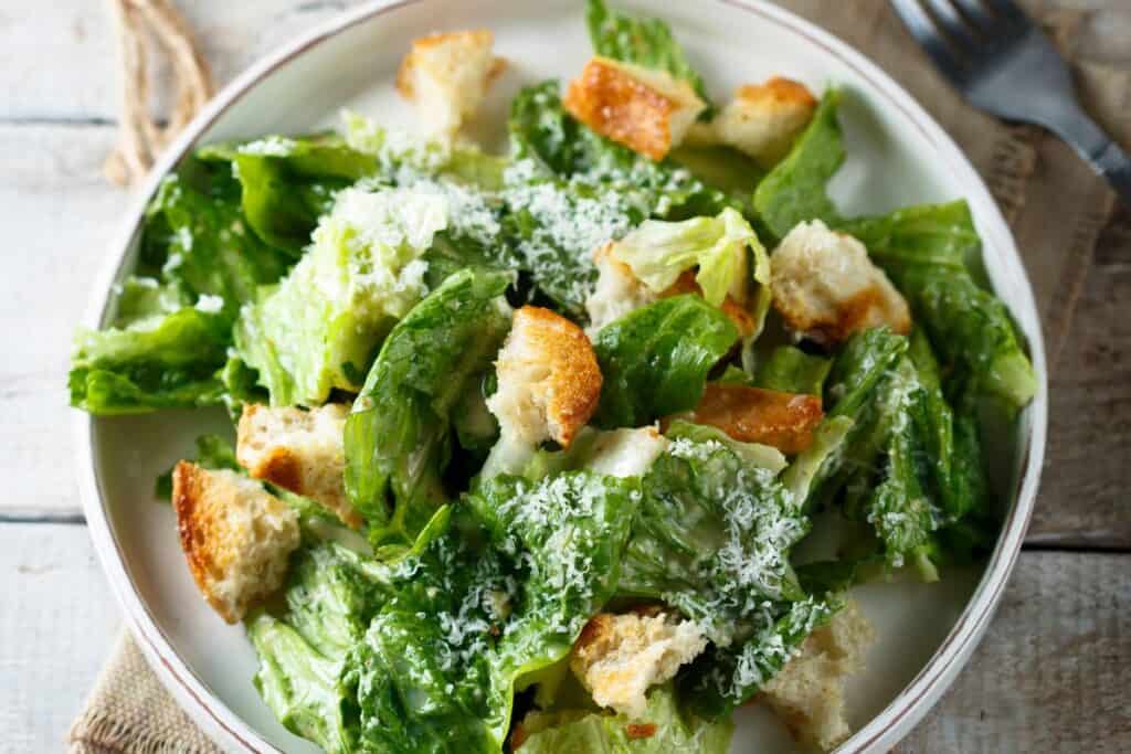 Ceasar salad in a white bowl