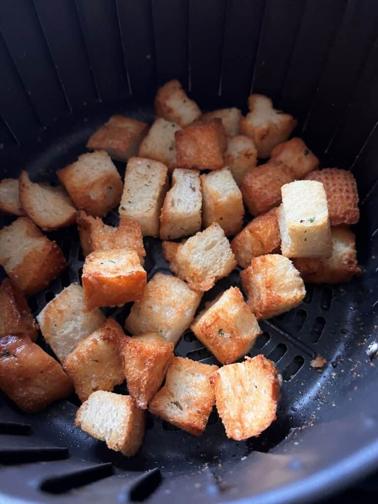 Cooked croutons in the air fryer basket