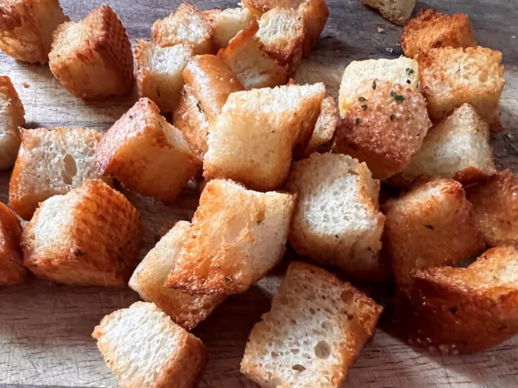 Close up of croutons cooling on a cutting board