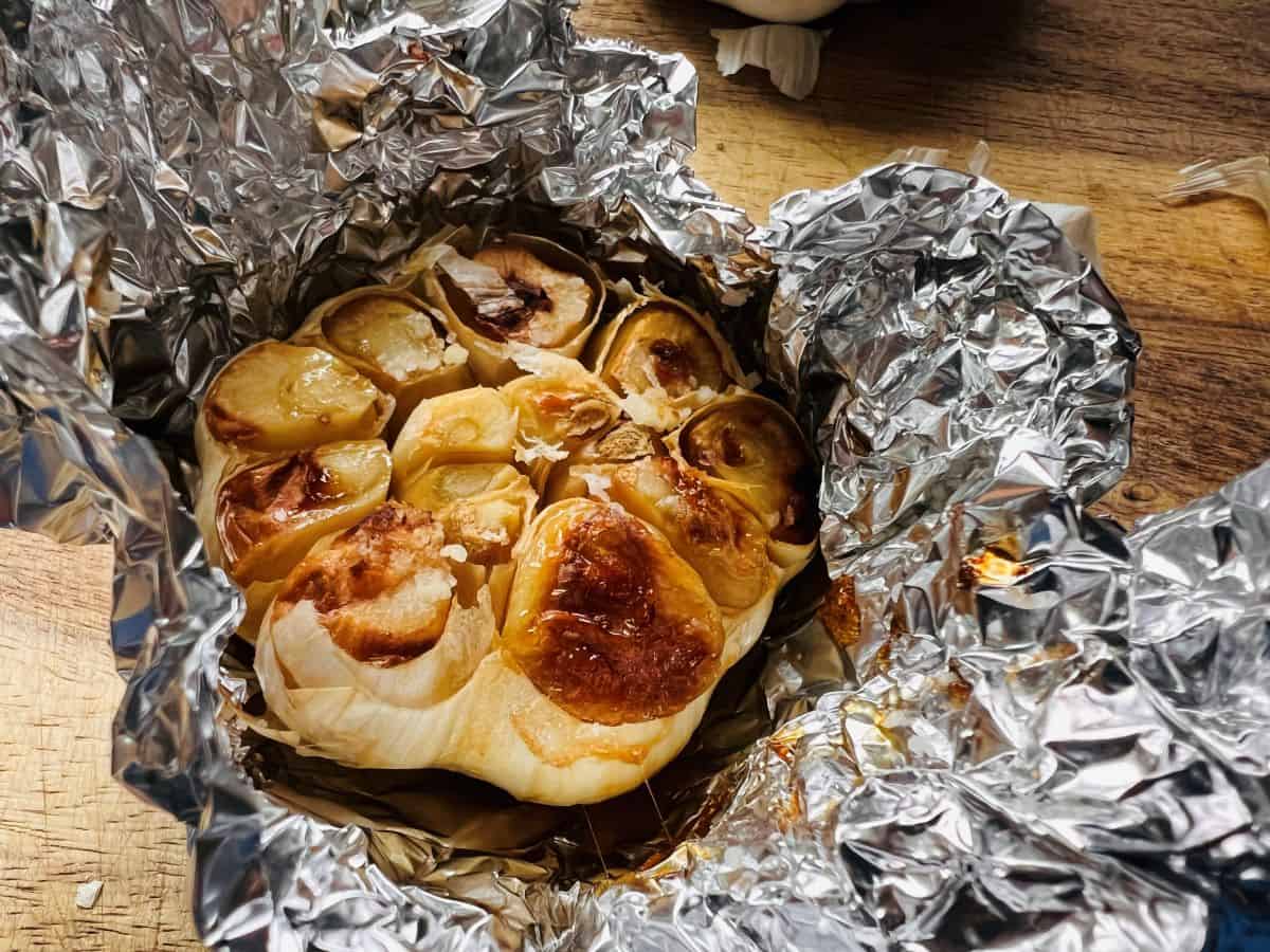 Golden brown roasted garlic in the foil