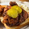 Hot Nashville chicken on toast with 2 pickle slices