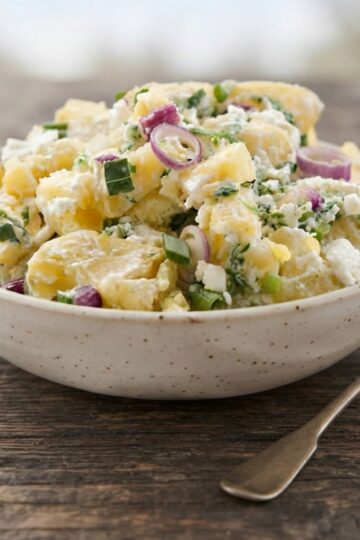 City Bargeque potato salad on a wooden table with a fork next to it