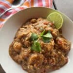 A white bowl full of hatch green chile pork stew
