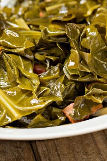 Finished collard greens in a white bowl