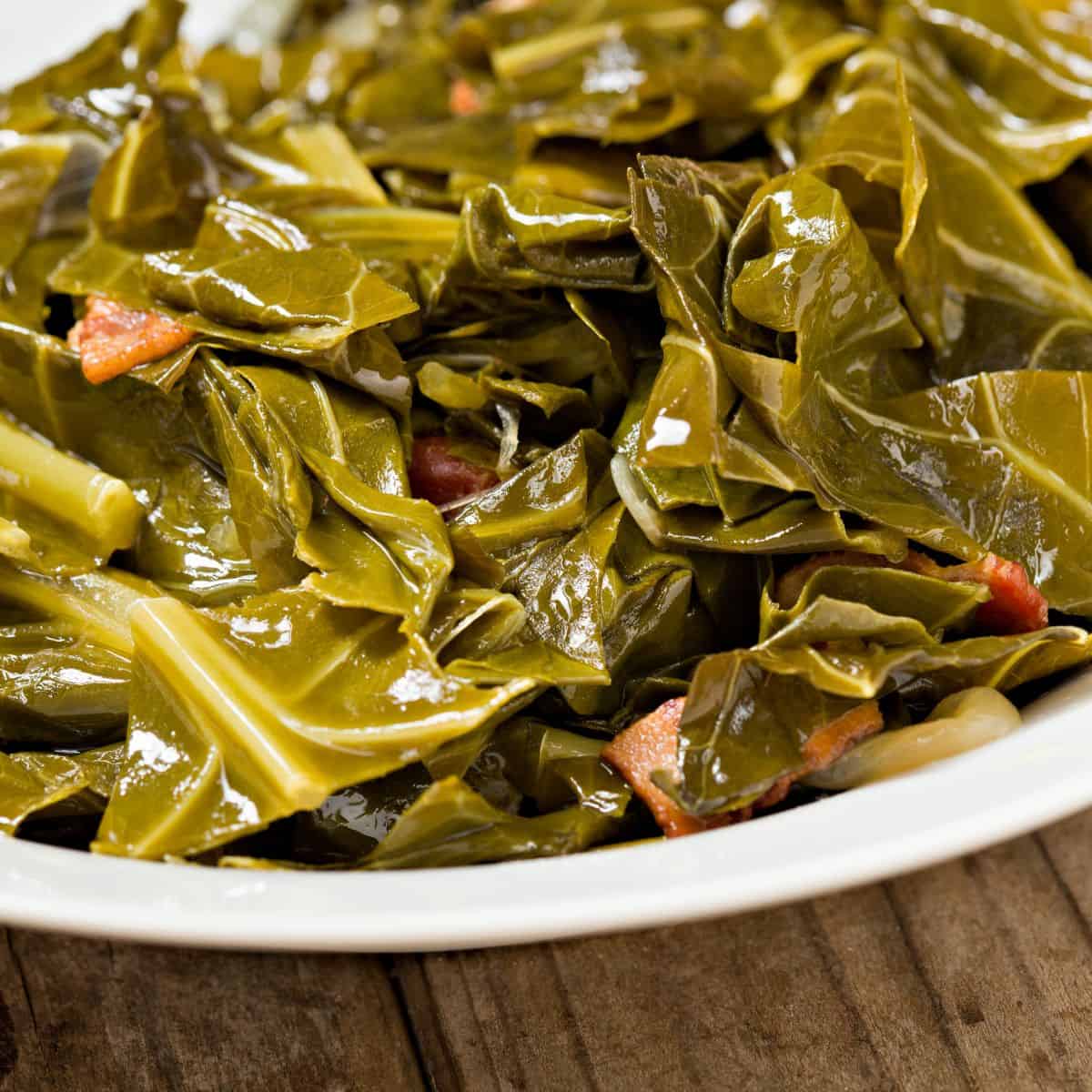 Finished collard greens in a white bowl
