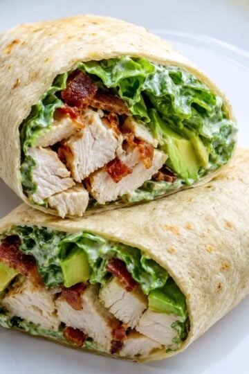 Chicken Caesar Wrap cut in half on a white plate