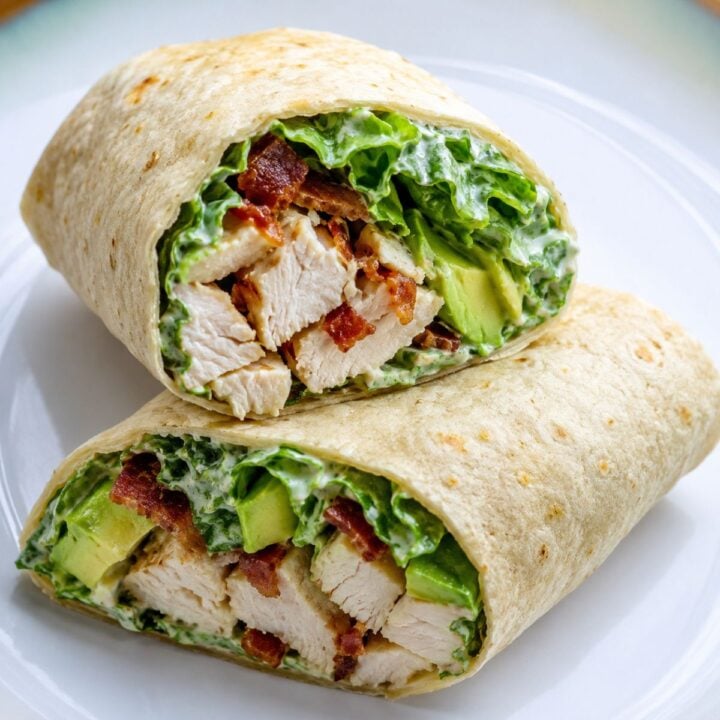 Chicken Caesar Wrap cut in half on a white plate