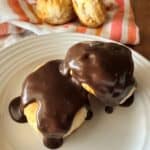 Biscuits on a plate covered in chocolate gravy - Two golden biscuits smothered in rich chocolate gravy.