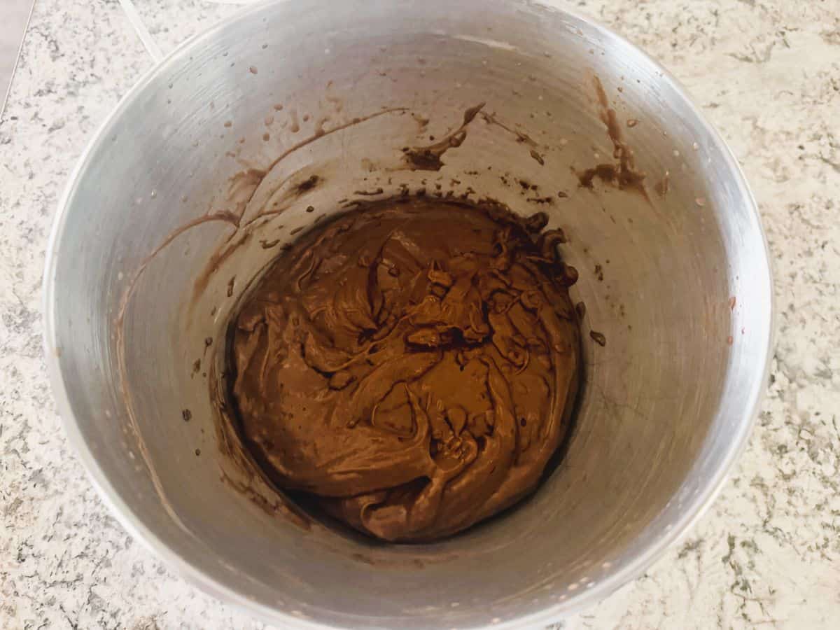 Bowl of prepared chocolate pudding with a smooth, glossy dark brown consistency.