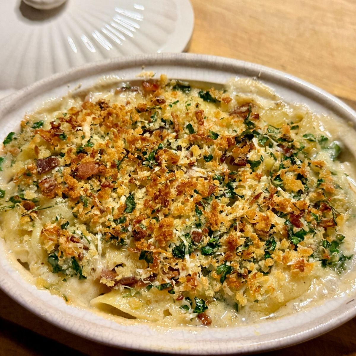 Golden baked lobster mac and cheese with a crisp breadcrumb topping