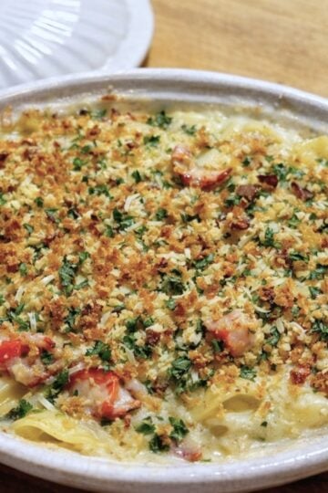 Golden baked lobster mac and cheese with a crisp breadcrumb topping