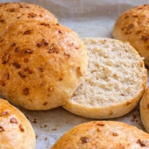 Finished onion rolls fresh out of the oven. One is cut in half