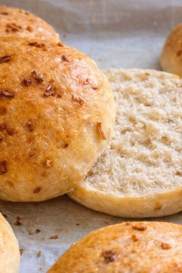Finished onion rolls fresh out of the oven. One is cut in half