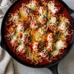 Cheesy skillet meatballs baked in homemade marinara sauce with melted mozzarella in a cast iron skillet